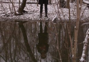 Chris Min reflected in the river water